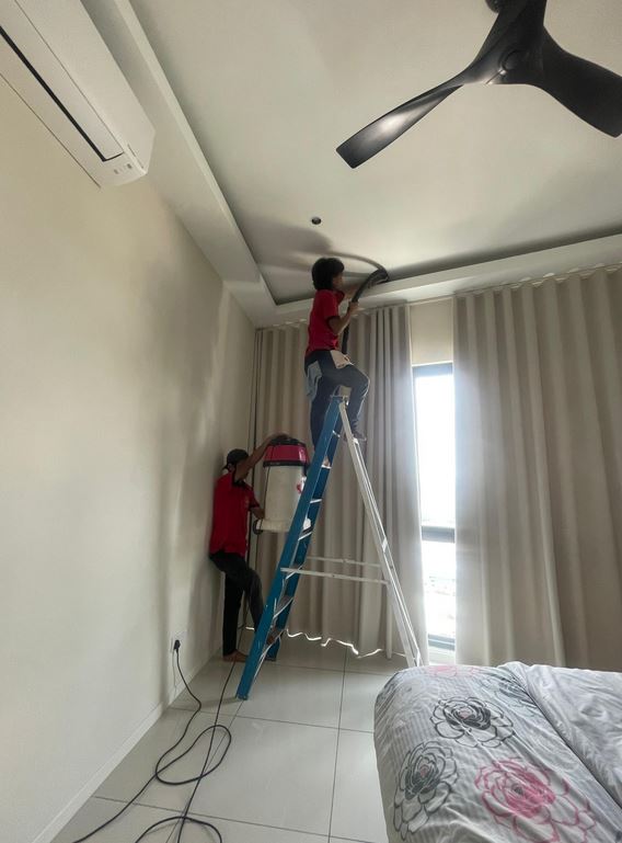 Ultra Cleaning crew cleaning ceiling coves in a vacant bedroom