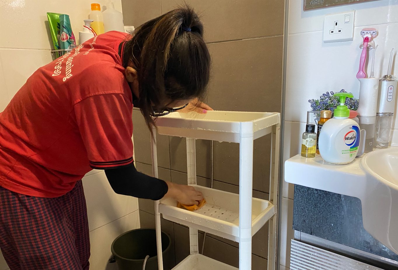 Ultra Cleaning specialist detailing a bathroom shelf in Bangsar